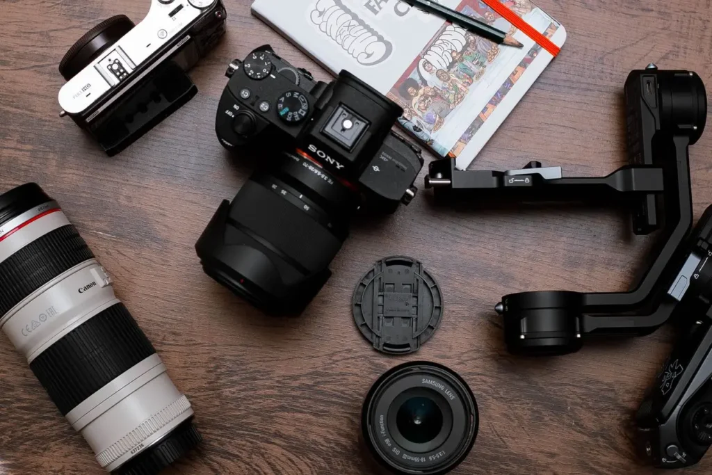 A tabletop display featuring a camera, lens, and photography accessories ready for use.